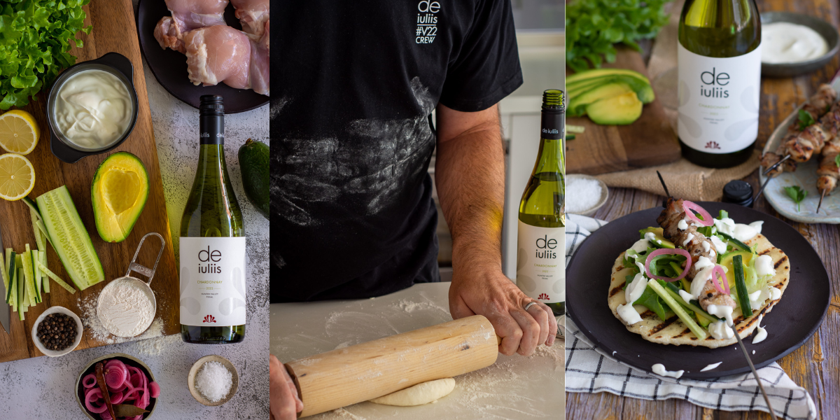 A bottle of chardonnay sits paired next to a delicious meal of greek style chicken skewers and homemade flatbread