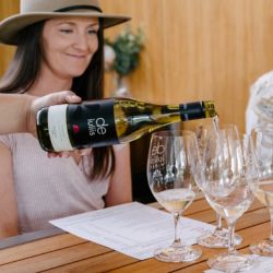 A glass of premium hunter valley wine is poured for a wine tasting in Pokolbin